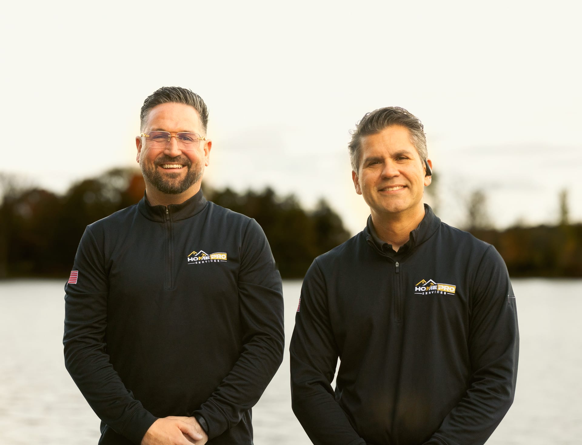 Tayler Adams and Lourenzo Da Silva, the owners of HomePro Services, side by side by a Michigan lake
