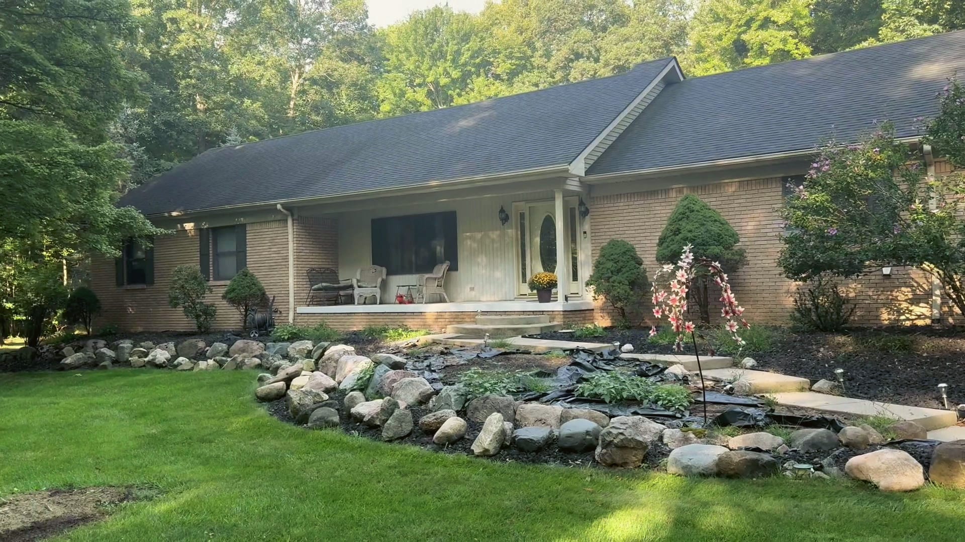 A finished brick ranch with a new porch and landscaping, a HomePro job