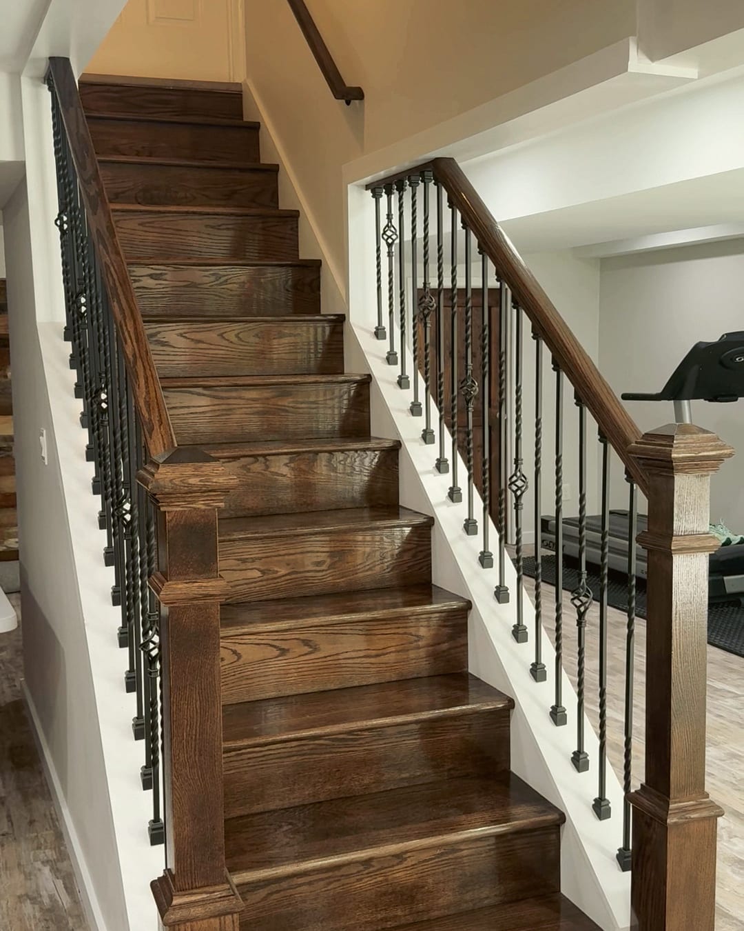 New oak stair treads with iron balusters and a white newel post, a HomePro job