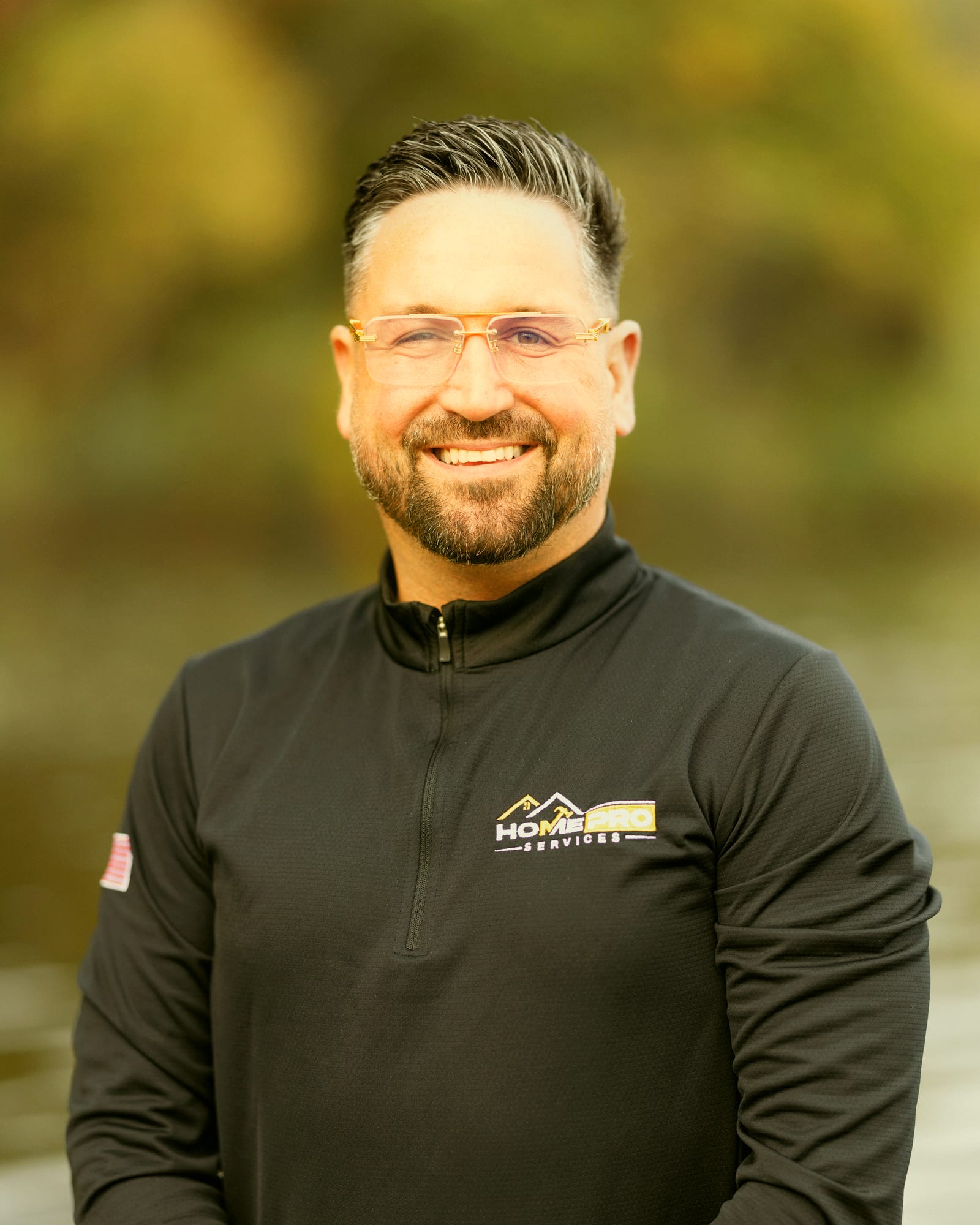 Tayler Adams, owner and CEO of HomePro Services, by a Michigan lake